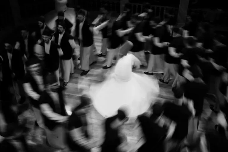 A captivating black and white image of whirling dervishes performing a traditional Sufi dance.